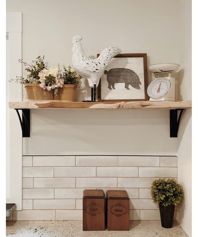 Black metal Niagara Bracket Support from Industrial Farm Co holding rustic wood shelf with farmhouse decor in kitchen setting