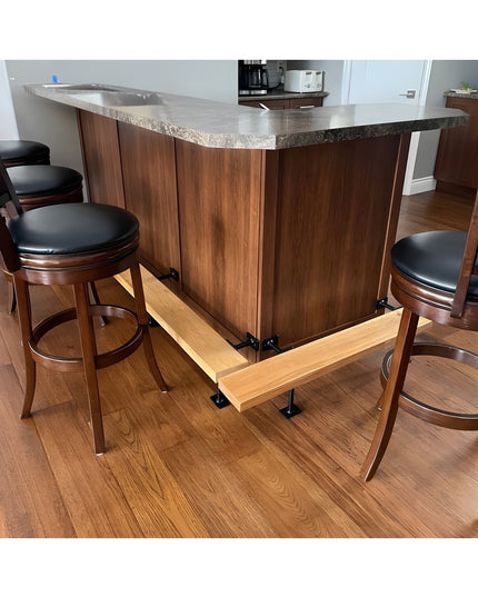 Black metal bar foot rail brackets supporting wooden foot rest under walnut kitchen island with bar stools - Industrial Fa...
