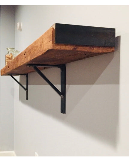 The Oneida black metal shelf bracket supporting rustic wood beam shelf mounted on white wall by Industrial Farm Co