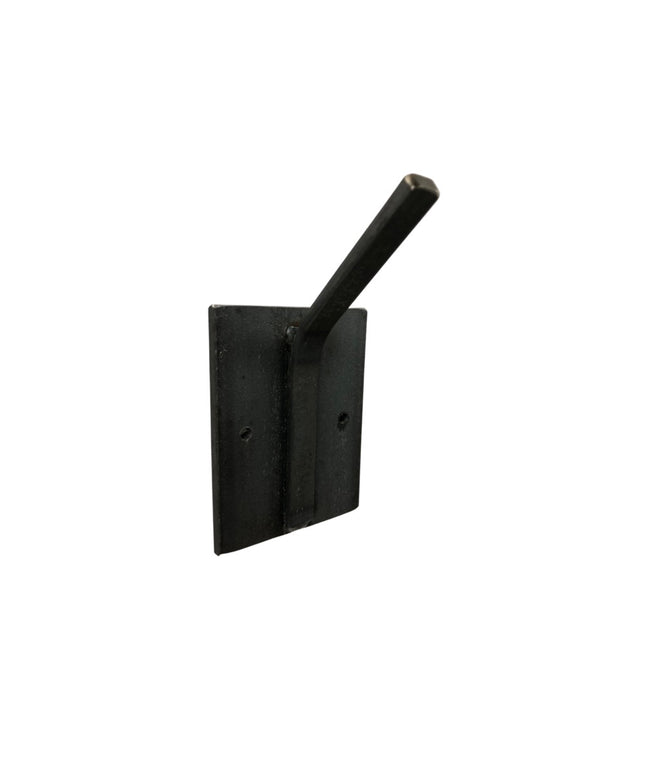 Black metal Tator wall mounted hook by Industrial Farm Co with square mounting plate and cylindrical rod against white bac...