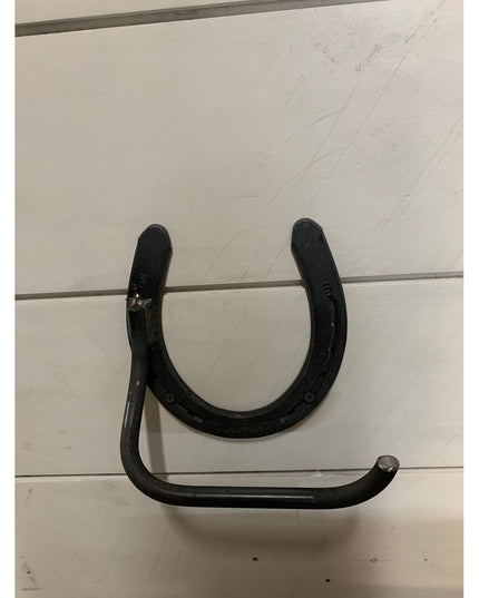 Black wrought iron Tierney Horseshoe Toilet Paper Holder by Industrial Farm Co mounted on white shiplap wall