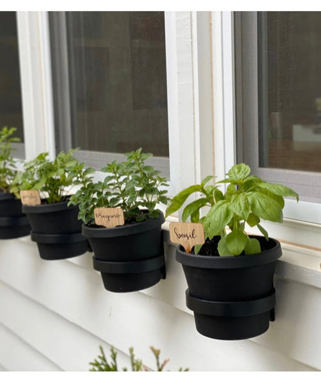 Black fabric Smoral Handmade Pot Holders by Industrial Farm Co displaying potted herbs with wooden plant labels on white w...