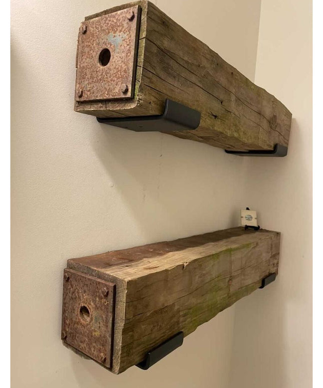 Rustic weathered wood floating shelves with metal end caps and black mounting brackets by Industrial Farm Co, showing natu...