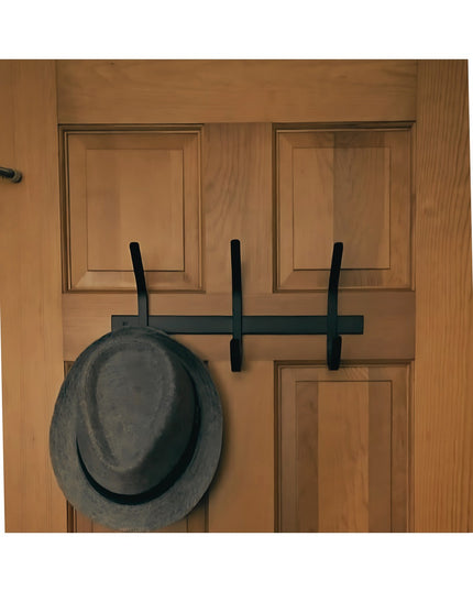 Industrial Farm Co Meredith Petite Double J black metal coat rack mounted on natural wood door with gray hat hanging