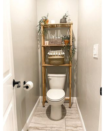 Industrial Farm Co Mitz bamboo over-the-toilet storage shelf with three tiers, decorated with plants and baskets in modern...