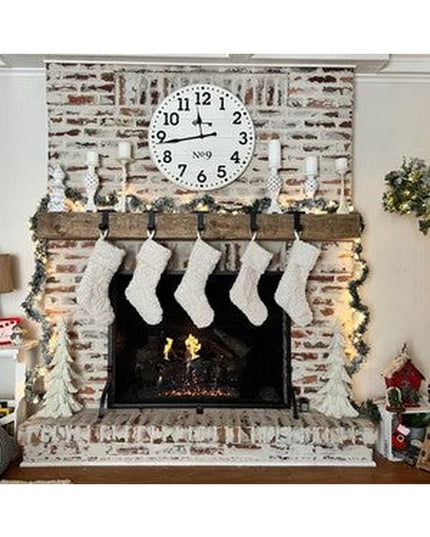 Rustic wooden Annie Stocking Holder by Industrial Farm Co mounted on brick fireplace mantel with five white knit Christmas...