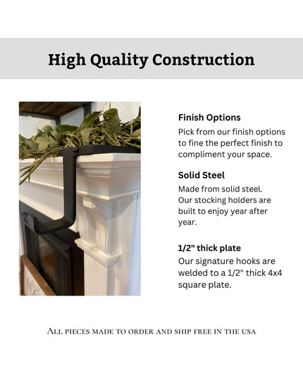 Black solid steel Annie Stocking Holder by Industrial Farm Co mounted on white mantle with greenery, showcasing durable co...