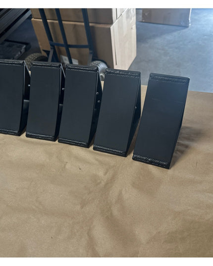 Five black metal Eleanor 5x5 Brackets by Industrial Farm Co arranged in a row on wooden surface, showing welded steel cons...