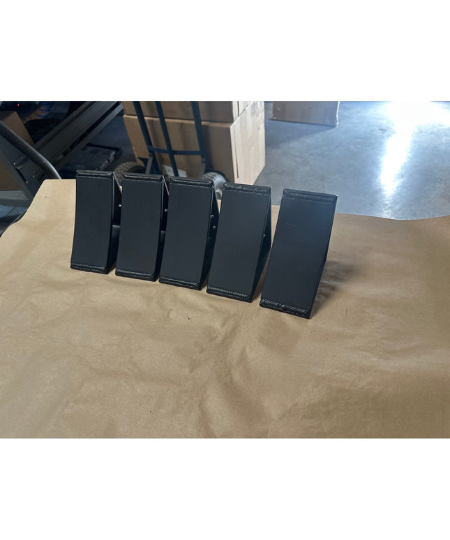 Five black metal Eleanor 5x5 Brackets by Industrial Farm Co arranged in a row on wooden surface, showing welded steel cons...