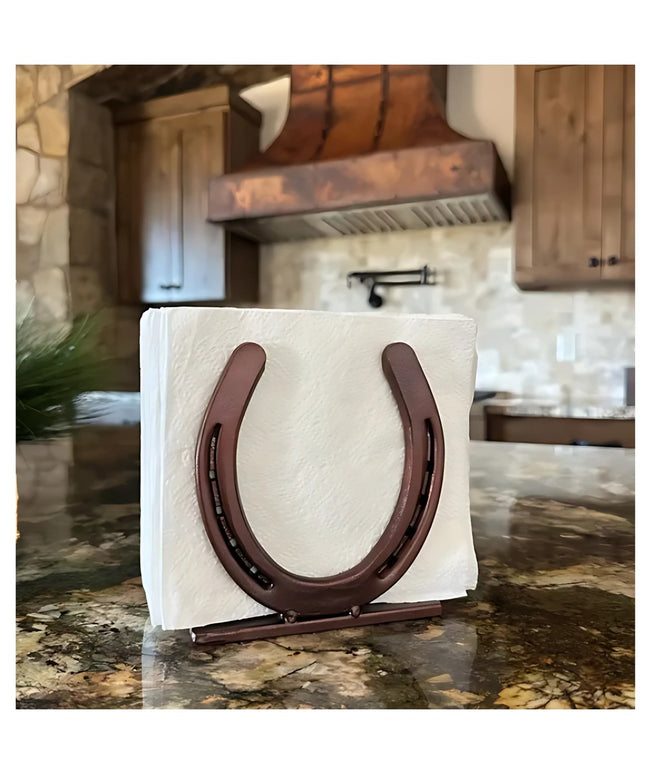 Industrial Farm Co rustic brown horseshoe napkin holder displaying white napkins on granite countertop in farmhouse kitchen