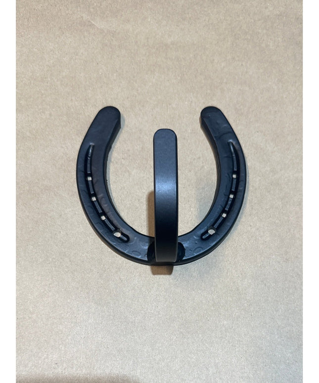 Heavy duty black metal horseshoe wall hook by Industrial Farm Co with nail hole details on beige background, farmhouse wes...