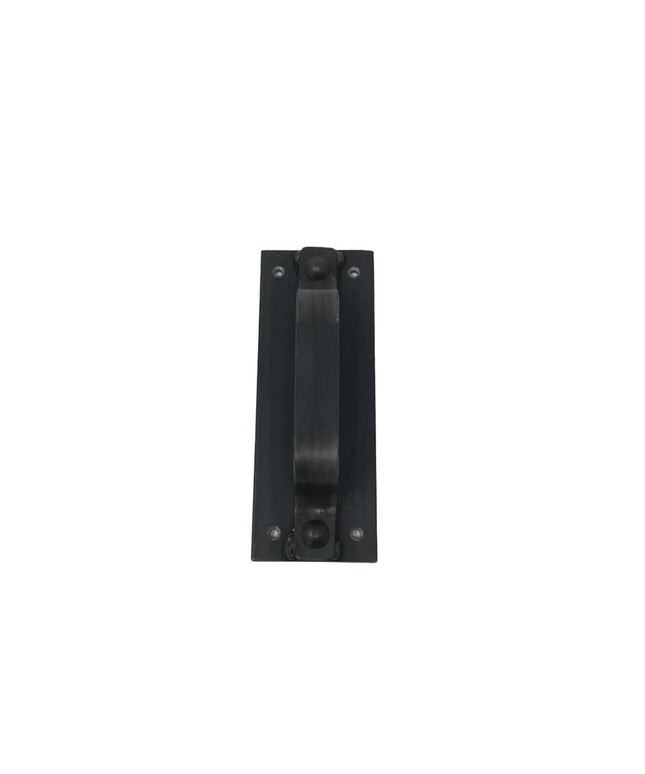 Black metal door handle called The Corning Handle by Industrial Farm Co, rectangular backplate with center pull bar and vi...