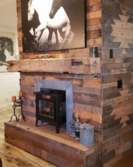 Wooden fireplace with rustic design and horse artwork above it.