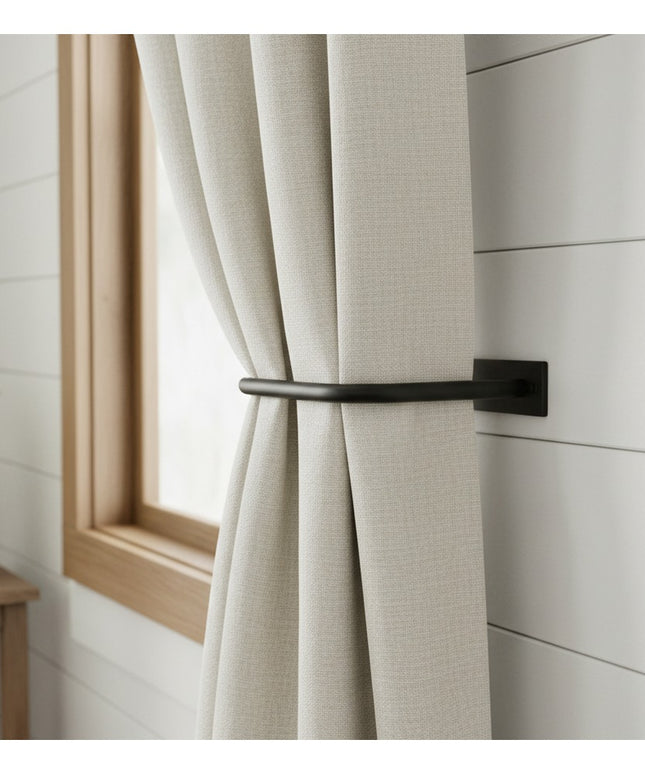 Black metal horse head curtain tie back holding beige linen curtains against white shiplap wall by Industrial Farm Co