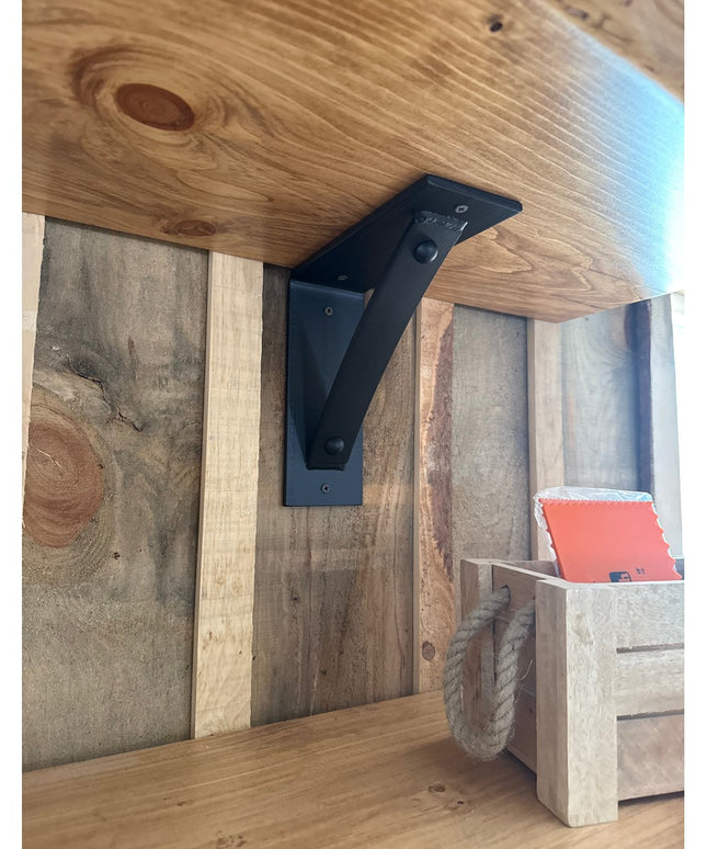 Black metal Cortland 3" shelf bracket with rivets by Industrial Farm Co supporting rustic wood shelf in farmhouse interior