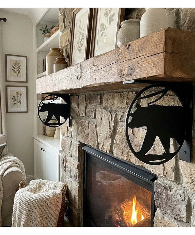 Black metal bear cutout L-bracket shelf supports holding rustic wood mantel on stone fireplace in cozy living room