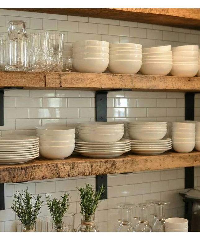 Heavy duty black steel L-shaped shelf brackets supporting rustic wood shelves with white dishes and glassware in modern fa...