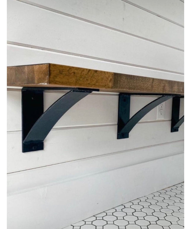 Black metal Lexica 4 inch wide shelf supports mounted under rustic wood beam on white shiplap wall by Industrial Farm Co