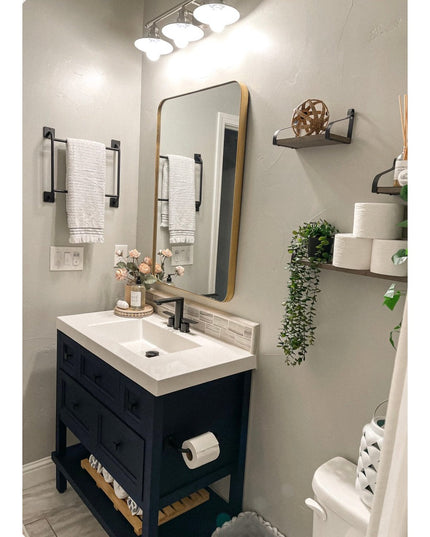 Black metal Mitz toilet paper holder by Industrial Farm Co mounted on dark blue bathroom vanity in modern farmhouse style ...