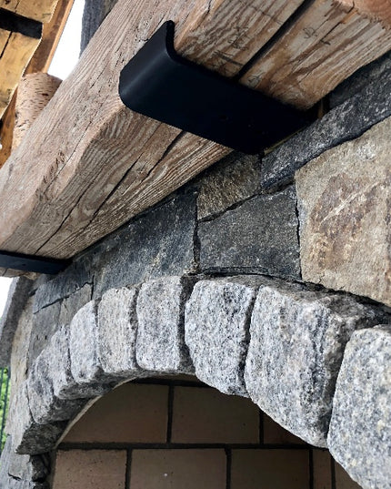 Stone archway with wooden beams and black metal bracket