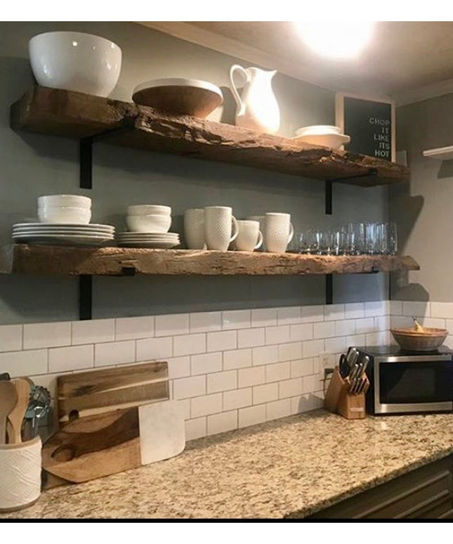 Black metal Z-style shelf brackets supporting rustic wooden shelves with white dishes in modern farmhouse kitchen by Indus...