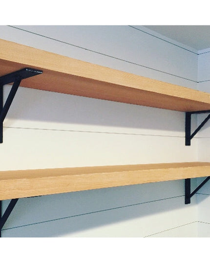 Oneida black metal shelf brackets supporting natural wood shelves mounted on white wall, showing triangular support design...