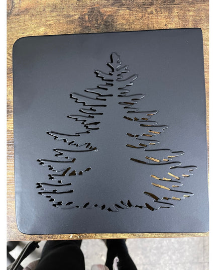 Black metal laser-cut evergreen tree design mantel end cap by Industrial Farm Co on rustic wood background