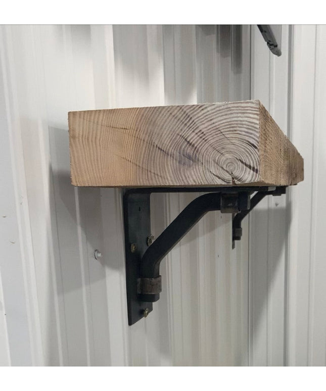 Black metal Rosamond shelf bracket supporting rustic wood beam shelf mounted on white wall, Industrial Farm Co decorative ...