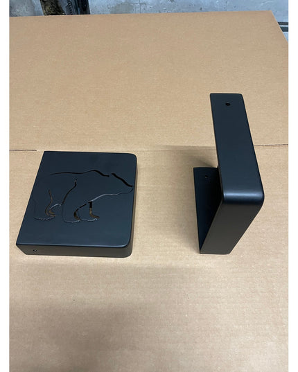 Black steel Vandiver Bear Mantel End Caps by Industrial Farm Co with engraved polar bear design on cardboard surface