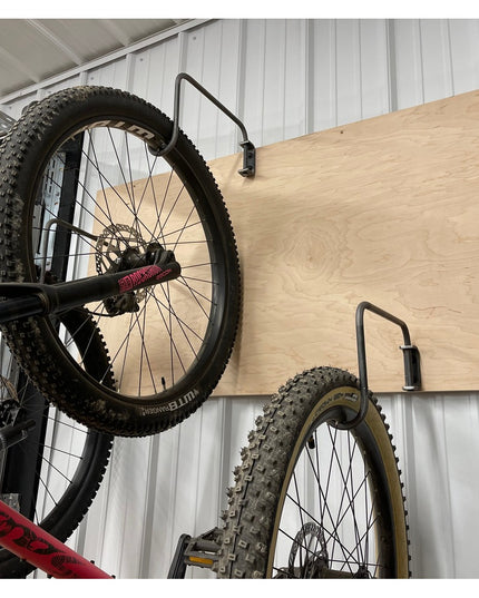 Logan Wall Mounted Bike Rack by Industrial Farm Co - wooden plywood hook system holding mountain bikes on corrugated metal...
