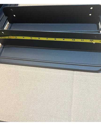 Herdon matte black metal wall-mounted shelf with two tiers being measured with yellow tape measure, showing kitchen spice ...