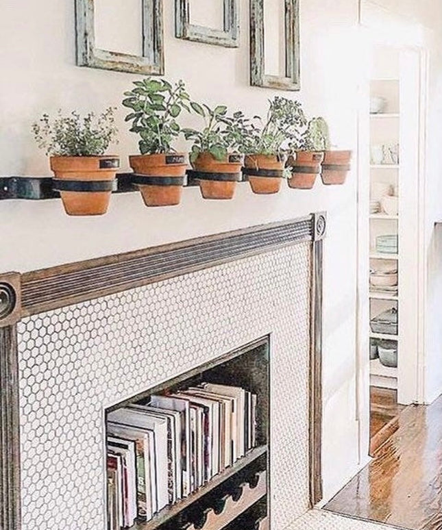 Yonkers Horizontal Steel Planter by Industrial Farm Co mounted on white fireplace mantel holding six terracotta herb pots ...
