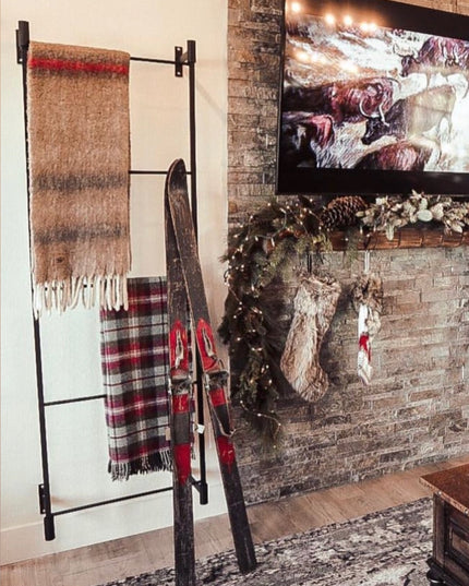 Living room with stone fireplace, TV, and Christmas decorations with '#WesternStyle' text.