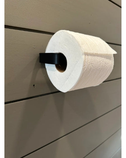 Black metal minimalist toilet paper holder mounted on white shiplap wall holding white toilet paper roll - The Manlius by ...