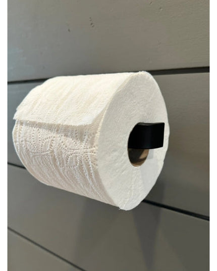 Black minimalist toilet paper holder mounted on gray bathroom wall holding white toilet paper roll - The Manlius by Indust...