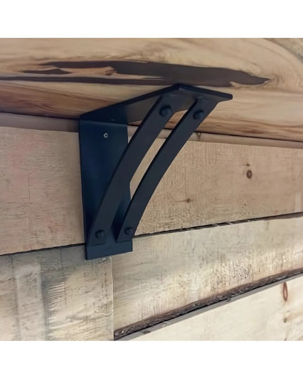 Black metal Jamestown 4" Wide Shelf Bracket mounted on rustic wooden beam shelving by Industrial Farm Co