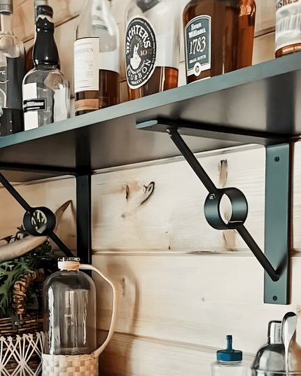 Black brackets holding wooden shelf