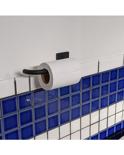 Black metal Mitz toilet paper holder by Industrial Farm Co mounted on white and blue mosaic tile wall holding white paper ...