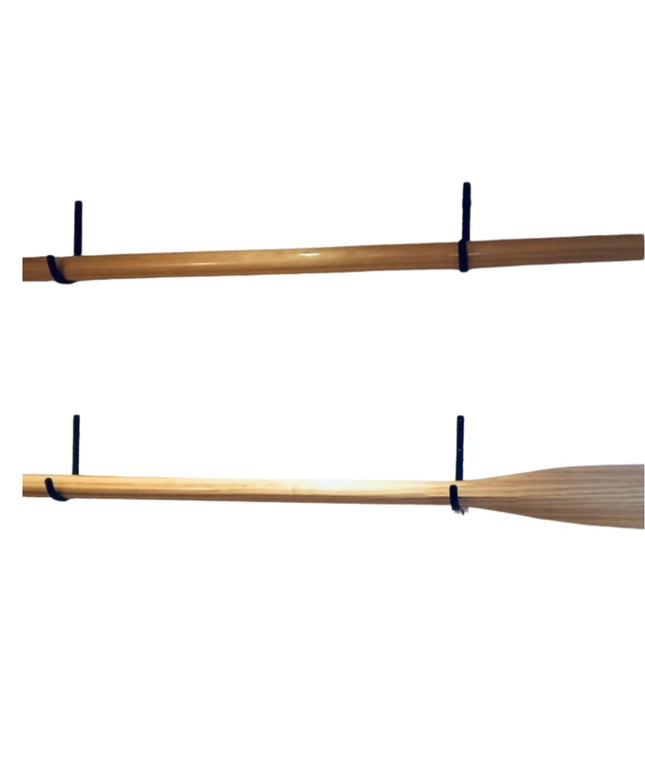 Two wooden oars mounted on black steel display hooks from Industrial Farm Co, showing different oar blade styles against w...