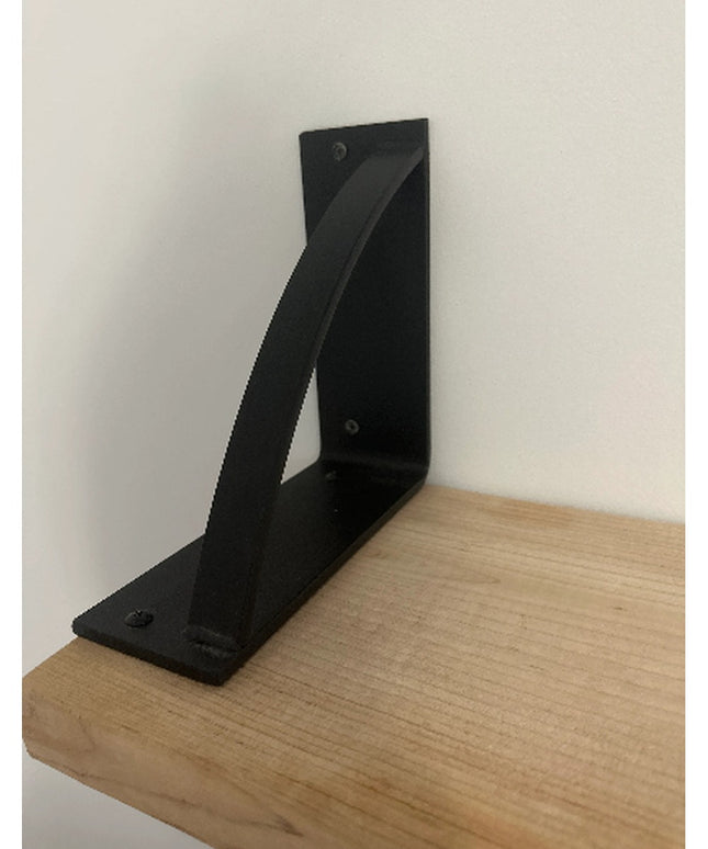Black steel Brie Bookshelf Bracket by Industrial Farm Co mounted on natural wood shelf against white wall showing L-shaped...