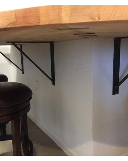 Black metal Oneida Shelf Brackets by Industrial Farm Co supporting wooden countertop with bar stools in modern kitchen