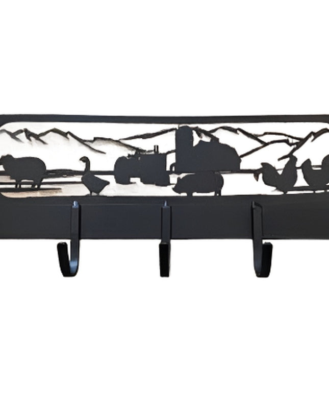 Black metal farmyard coat rack with 5 hooks featuring silhouettes of farm animals, tractor, and mountains in rustic countr...