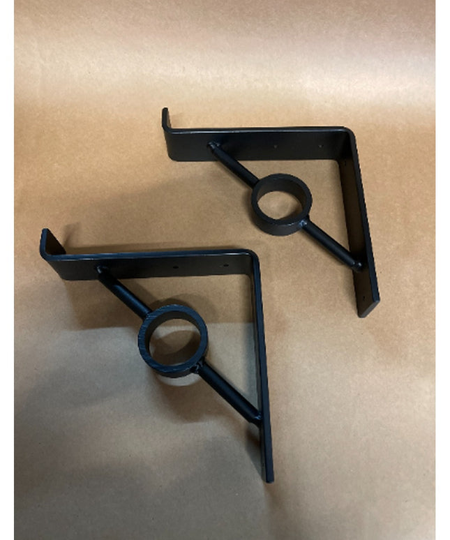 Two black metal Simon Decorative Support Brackets by Industrial Farm Co with triangular design and circular center detail ...