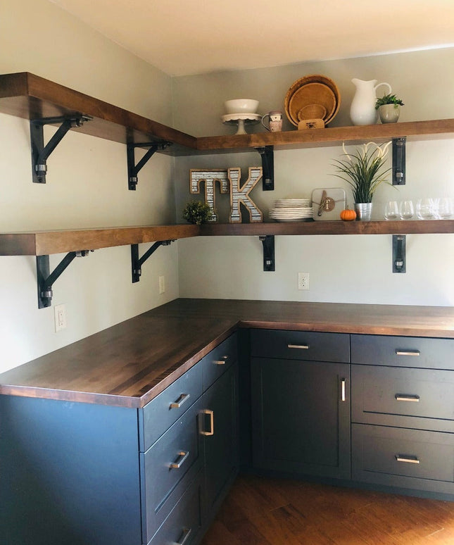 Black metal Butch Shelf Supports by Industrial Farm Co holding rustic wood shelves in modern farmhouse kitchen with navy c...