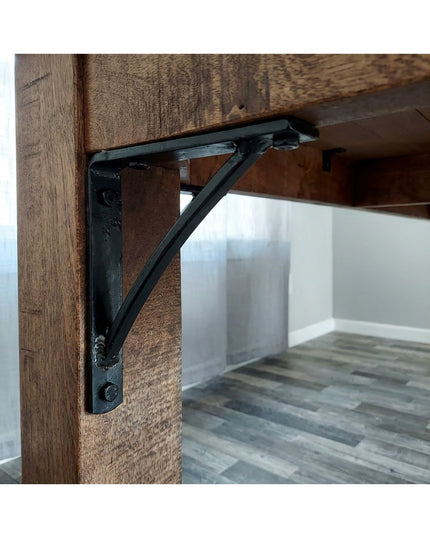 Black steel Oak Hill 1" Industrial Shelf Bracket with curved support bar mounted on rustic wood beam, handmade heavy duty ...