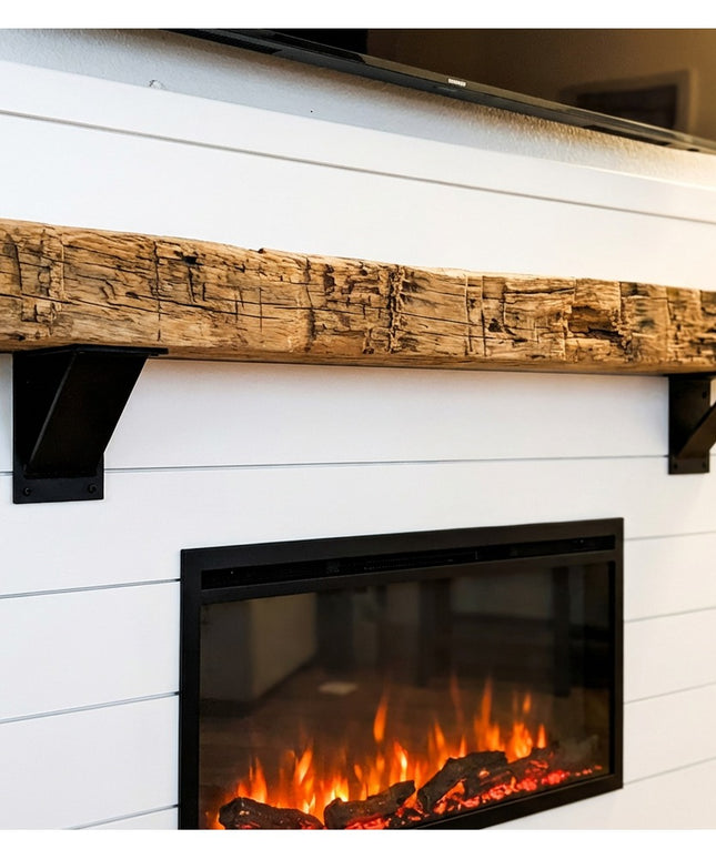 Heavy duty black steel industrial shelf brackets supporting rustic reclaimed wood mantel above white shiplap electric fire...