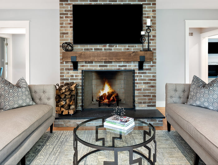 Living room with a fireplace, TV, and two couches.
