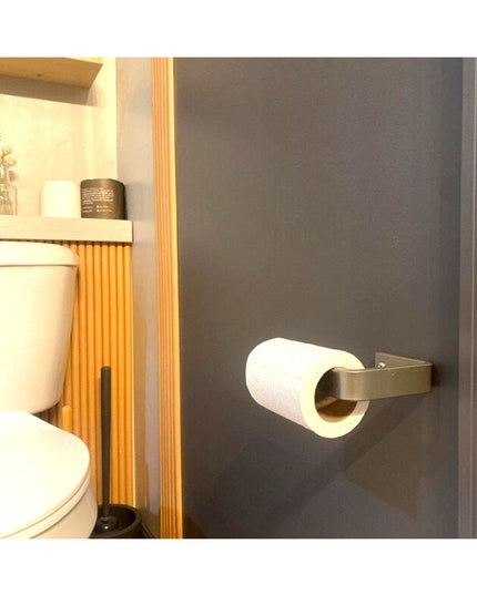 Industrial Farm Co Manlius brushed brass minimalist toilet paper holder mounted on dark gray bathroom wall with white toil...