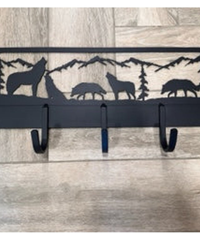 Black metal wall-mounted coat rack featuring wolf and wildlife silhouettes with mountain landscape design, 5 hooks by Indu...